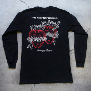 image of black long sleeve tee laid flat on cracked concrete floor. full back print with cream on top that says the menzingers & two hearts in red with a sword through them. the hearts have cream fire on top barb wire wrapped around. they are bleeding in cursive below strangers forever.