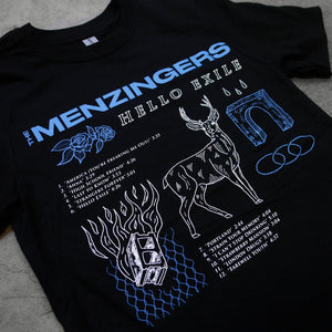 angled close up image of black tee shirt laid flat on cement floor as  background. tee has full chest print. along the top in blue saus the menzingers and has several images below. including blue flower, white deer, the words hello exile in white, and cinder block and the track list to the menzingers album hello exile.
