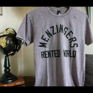 image of a ash stone wash tee shirt on a hanger on the right and a black globe on the left. tee has full chest print in black with arched text on the top that says menzingers. below that horizonatlly it says rented world.